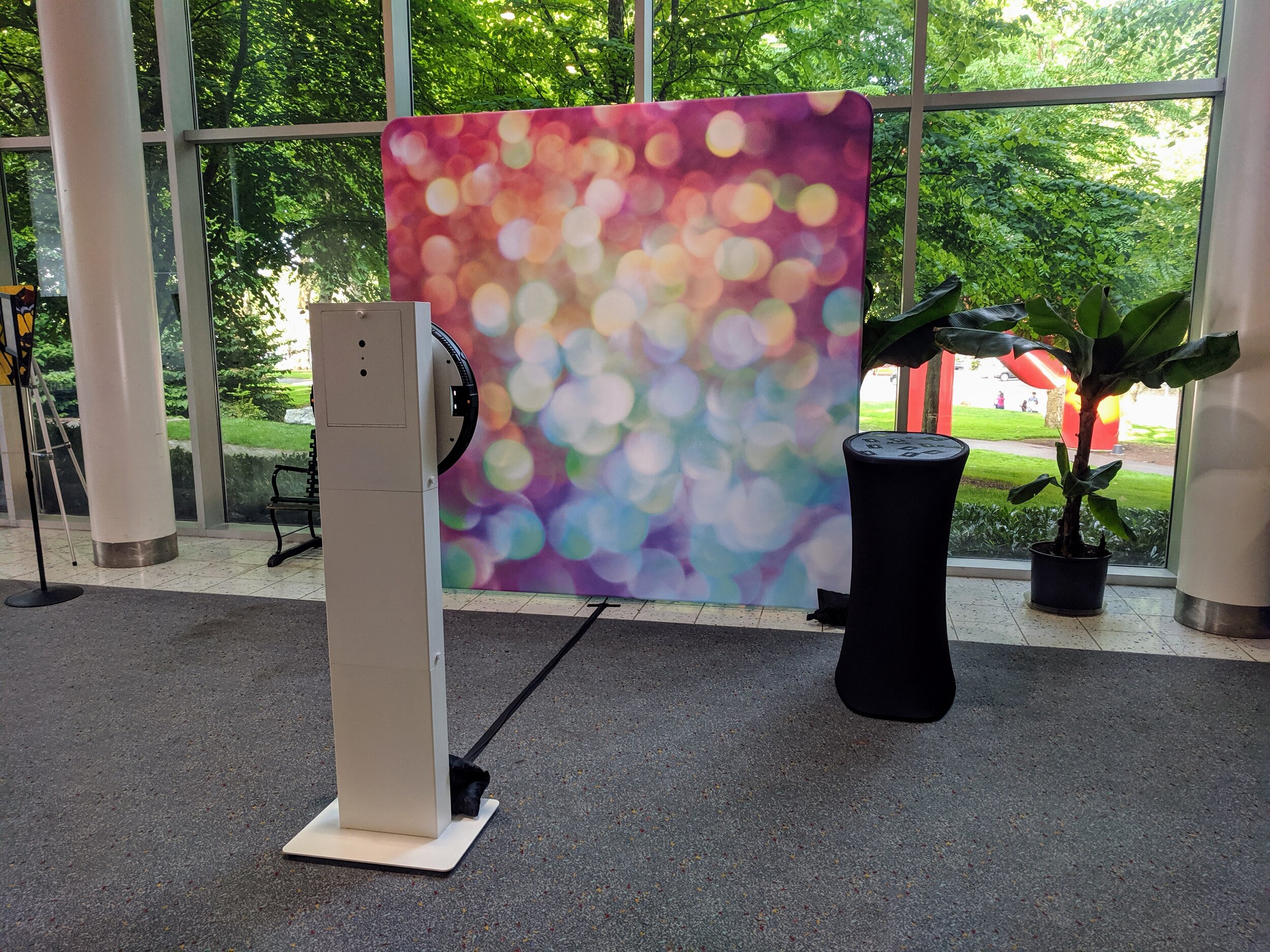 Social Photo Booth set up with colorful bokeh backdrop in bright atrium