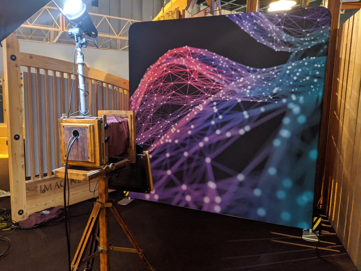 Vintage photo booth with purple geometric mesh backdrop and warm umbrella light