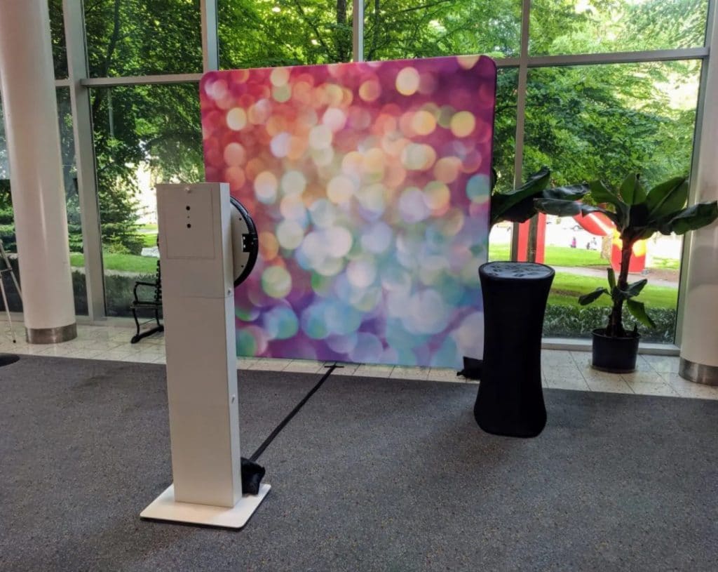 Social Booth with bokeh backdrop set up in glass-walled corporate atrium