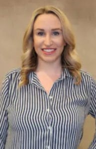 Headshot of smiling woman in striped blouse for VIP Badge Booth print
