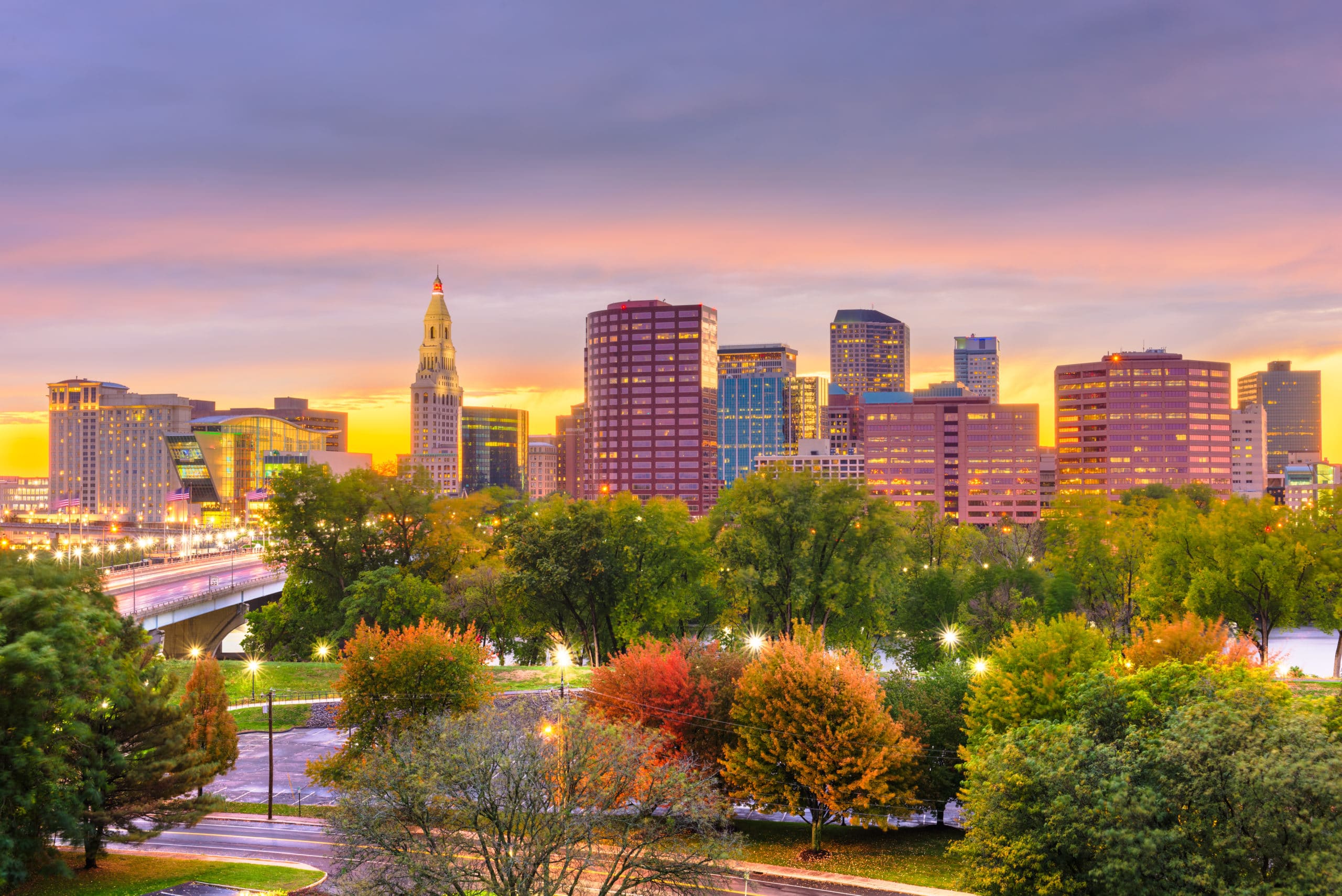 Hartford Connecticut downtown skyline at sunset with autumn trees in foreground