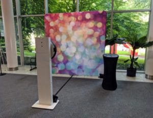 Social Booth with bokeh backdrop set up in glass-walled corporate atrium