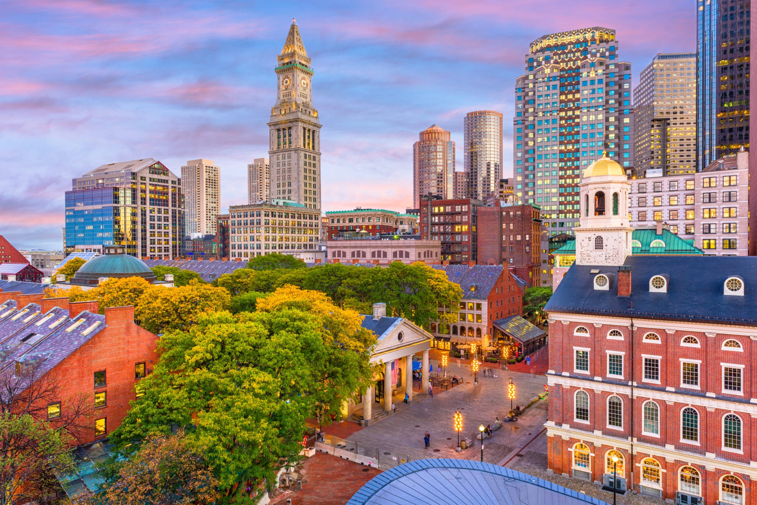 Boston Massachusetts skyline at sunset with Quincy Market and Custom House Tower