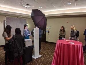 VIP Badge Booth station with ring light and host at corporate hotel event