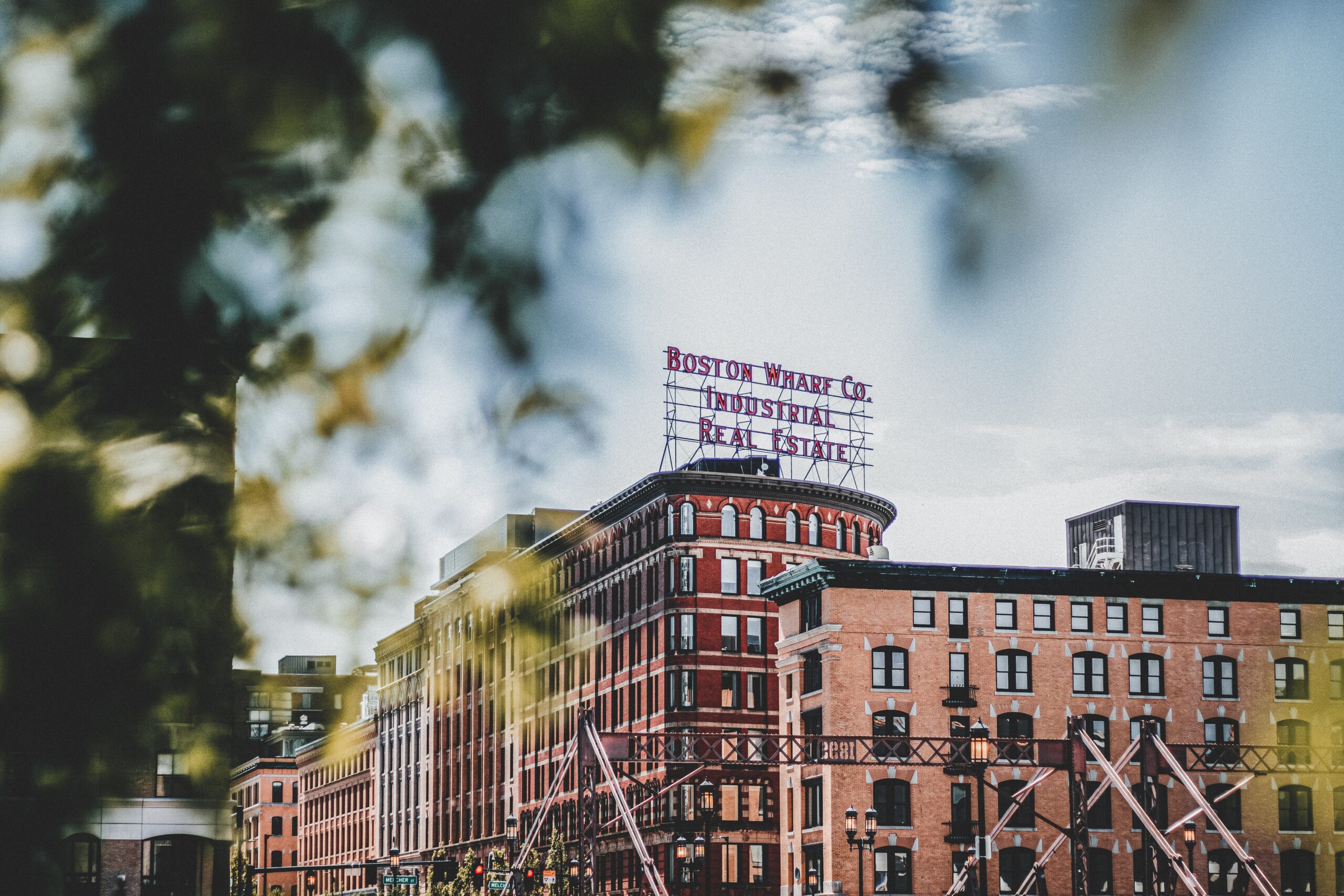 Boston Wharf Co Industrial Real Estate building with brick warehouses in background