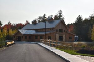 Bull Meadow event barn exterior with autumn trees and paved driveway