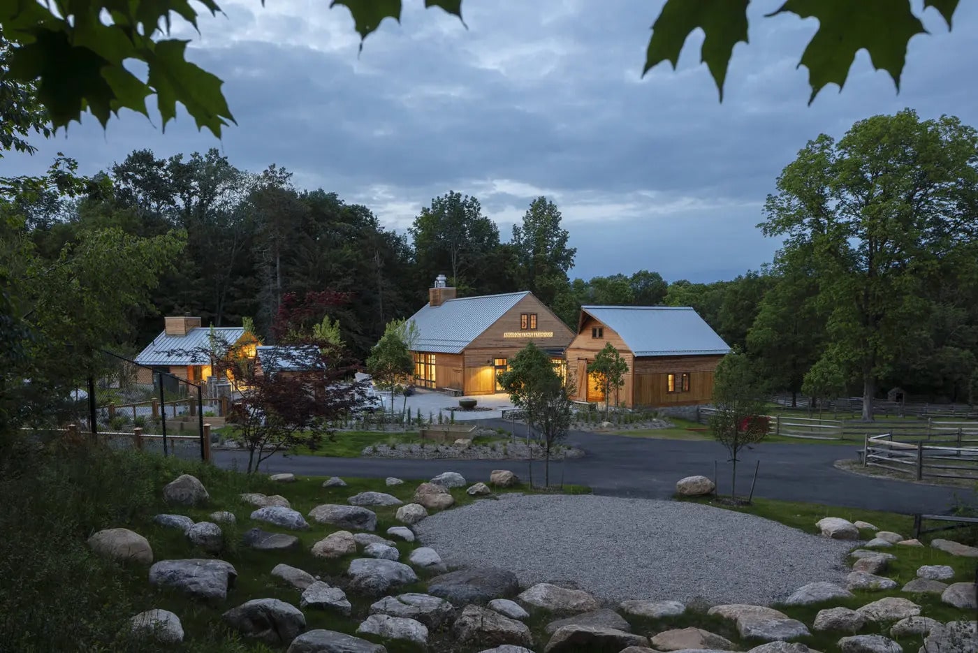 Stone country wedding venue exterior at twilight with manicured landscaping