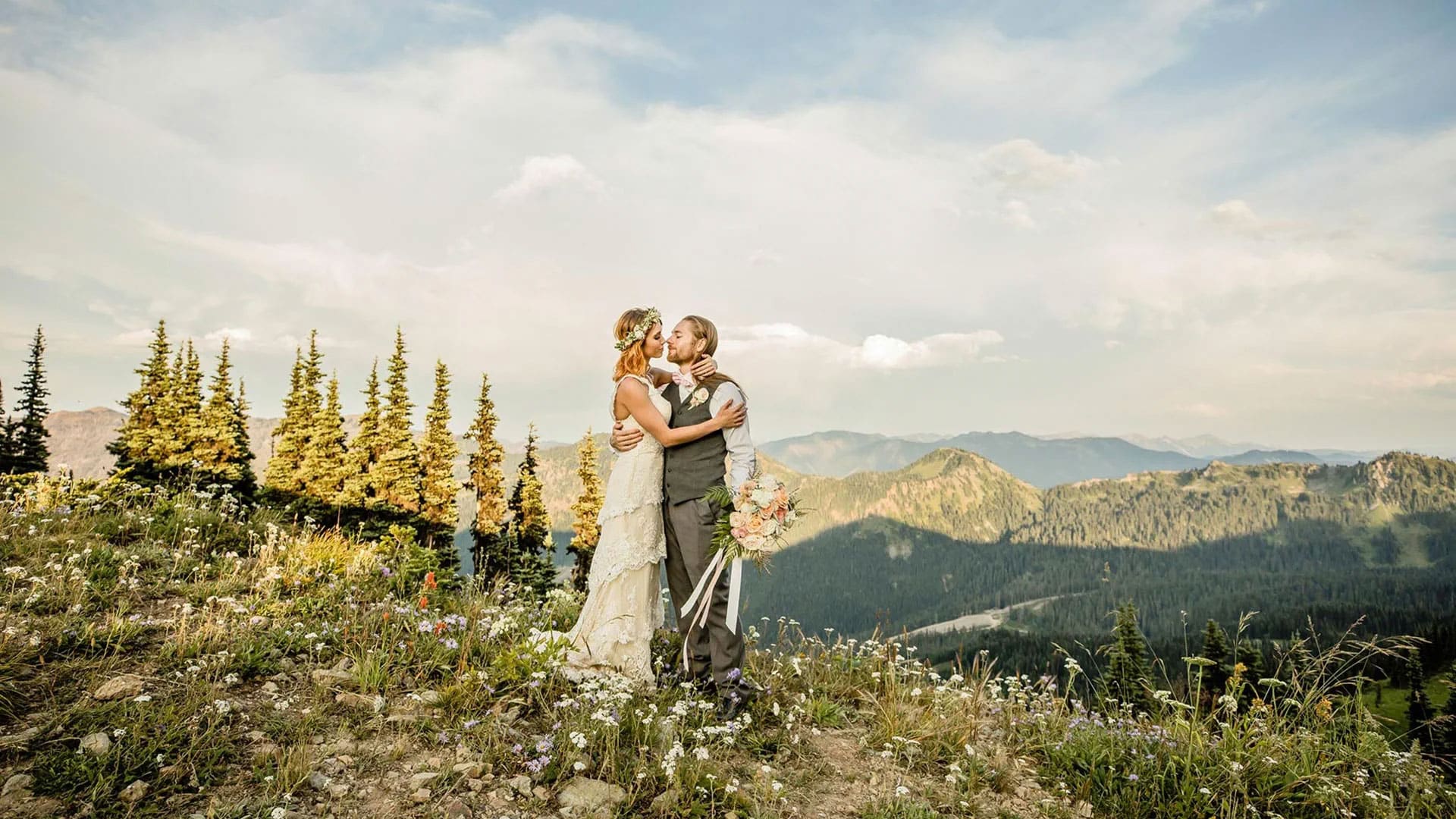 Bride and groom embracing at Crystal Mountain Resort with mountain views