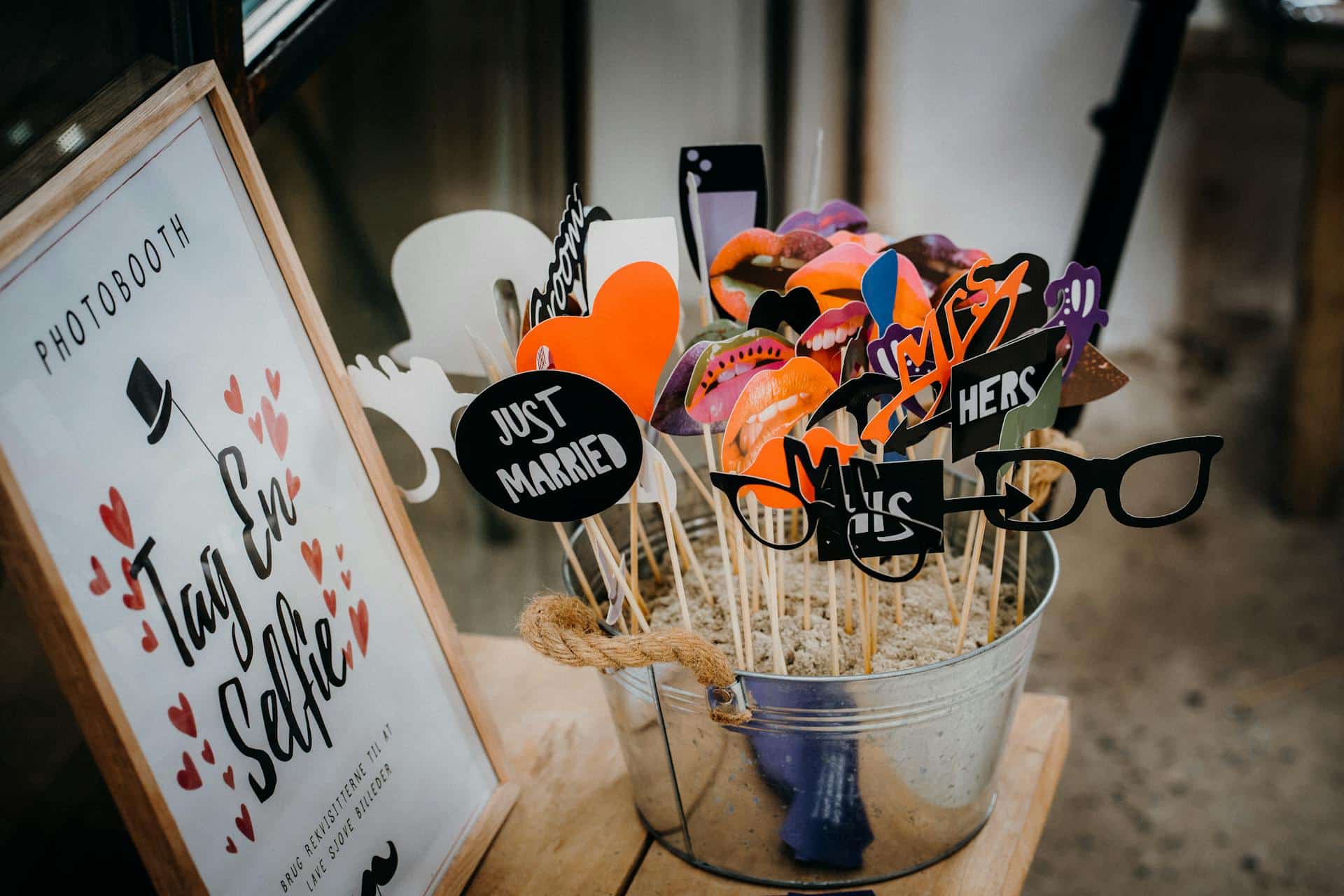 Bucket of wedding photo booth props including Just Married and Mr Mrs signs